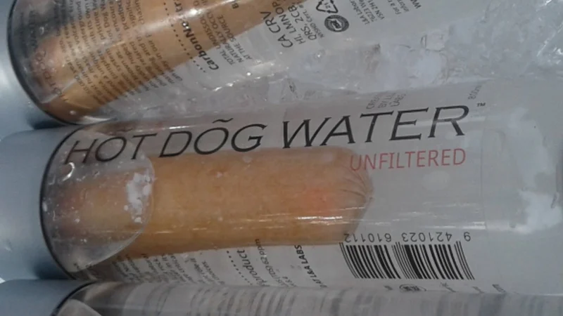 Close-up of Hot Dog Water bottle with a hot dog floating inside labeled 'Unfiltered'
