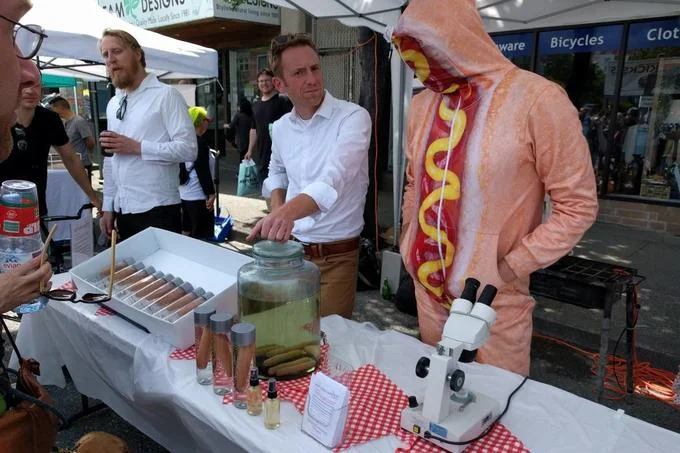 Hot Dog Water booth at Vancouver Car-Free Day with a person in a hot dog costume and product display