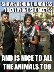Human Kindness Moment — Impact-font meme with man and woman at public event captioned about showing genuine kindness and being nice to animals.