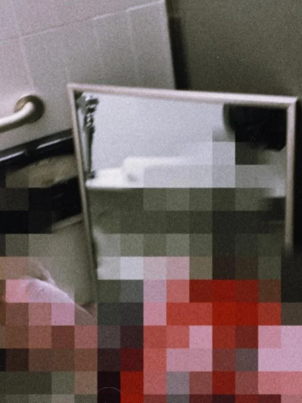 Hunter Schaffner and Holden Goyette Mirror Incident — Pixelated bathroom scene with mirror and censored red imagery
