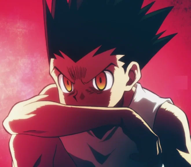 Hunter x Hunter — Gon Freecss adult form with fierce yellow eyes and spiky hair on red background