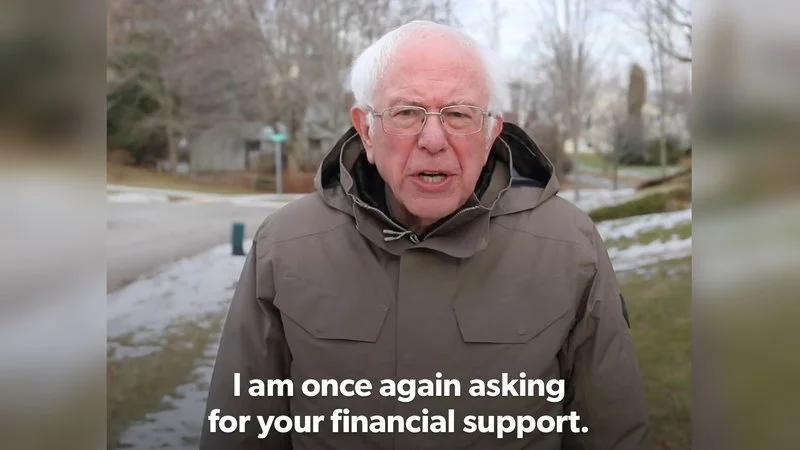 I Am Once Again Asking For Your Financial Support — Bernie Sanders on snowy suburban street in olive coat with canonical financial support subtitle.