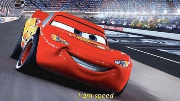 I Am Speed — Pristine high-quality screenshot of Lightning McQueen on racetrack in iconic confident pose.
