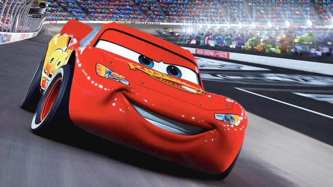 I Am Speed — High-quality screenshot of Lightning McQueen on racetrack in confident racing pose.