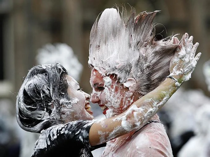 I Came — Two women covered in white foam laughing together