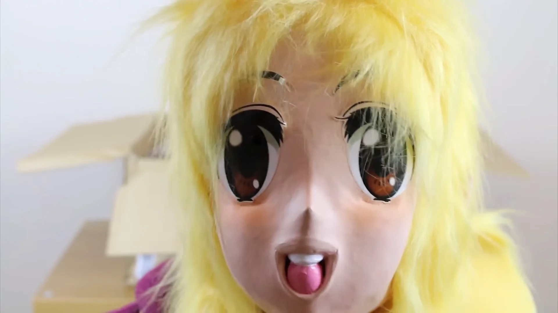 I Hate Everything — Yellow-haired anime kigurumi mask with big eyes and tongue out