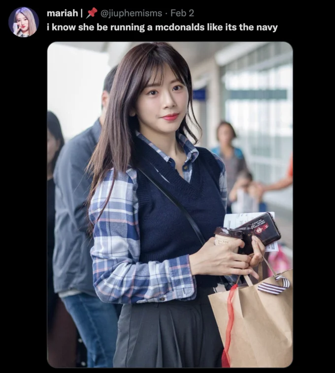 I Know She Be Running A McDonald's Like It's The Navy — Tweet with the McDonald's navy caption over a photo of a young woman at an airport holding coffee and a