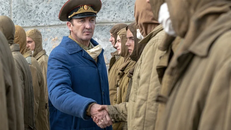 I Serve The Soviet Union — Original scene from HBO's Chernobyl miniseries showing General Nikolai Tarrakov in uniform shaking hands with soldiers in tan