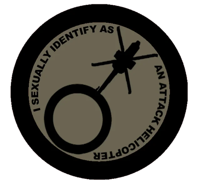 Circular badge with helicopter icon and text 'I Sexually Identify As An Attack Helicopter'