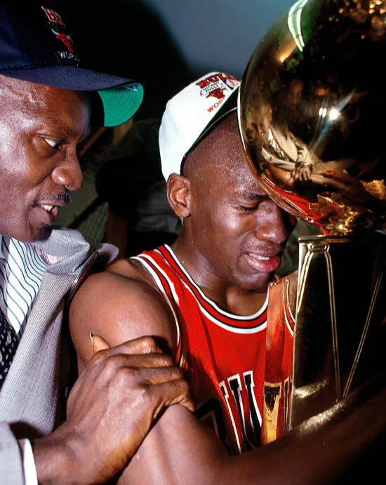 I Used to Pray for Times Like This — Michael Jordan crying while holding NBA championship trophy, embraced by his father.