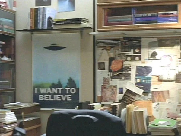 Fox Mulder's office featuring the 'I Want to Believe' UFO poster on the wall