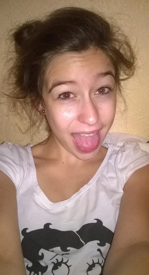 I Woke Up Like This — Young woman with a messy bun sticking her tongue out in a comedic morning selfie.