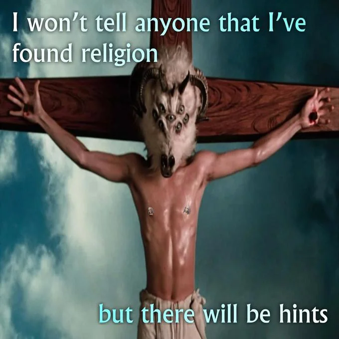I Wouldn't Tell Anyone I Won The Lottery, But There Will Be Hints — Man on a cross wearing a goat skull mask with the caption about finding religion with hints