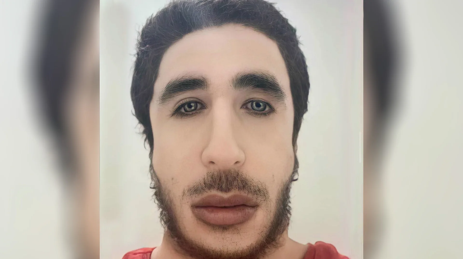 Ibo Eshak Ibohammad Eshakur — Close-up portrait of Ibo Eshak with dark hair and thick eyebrows against a blurred duplicate of the same photo
