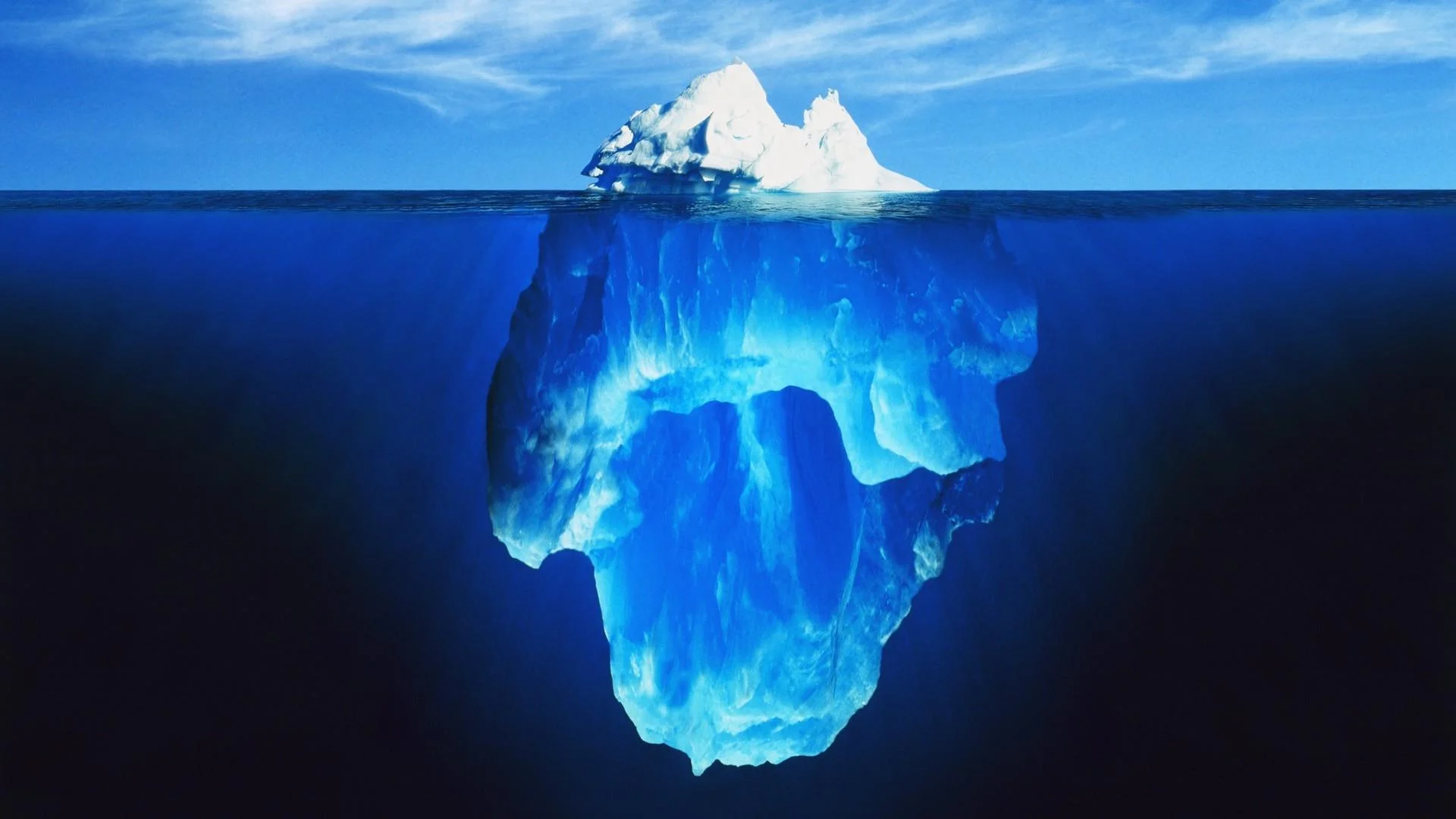 Iceberg Charts — Stock photo of an iceberg with a small tip above the ocean surface and a massive submerged portion below