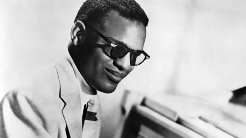 I'm Gonna Pretend I Didn't See That — Black-and-white photo of Ray Charles in sunglasses seated at a piano
