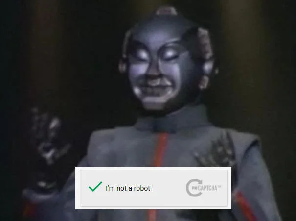 Vintage sci-fi robot character with a green-checked 'I'm not a robot' CAPTCHA overlay
