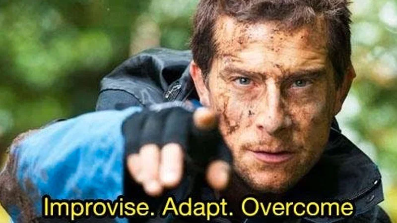 Improvise Adapt Overcome — Crystal-clear template of survival expert pointing directly at camera with intense focus against blurred natural background with