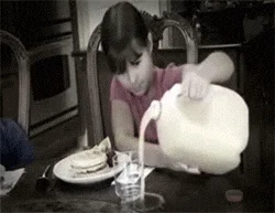 Infomercial Fails — Black-and-white GIF of child at table struggling to tilt and pour from heavy large pitcher.