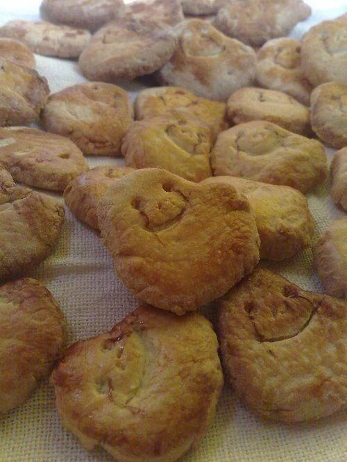 Internet Is Leaking — Collection of fried dough pastries decorated to resemble simple meme faces with basic features.