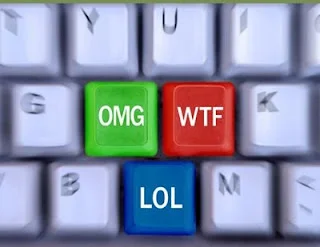 Internet Slang — Computer keyboard close-up featuring green 'OMG', red 'WTF', and blue 'LOL' colored keys.