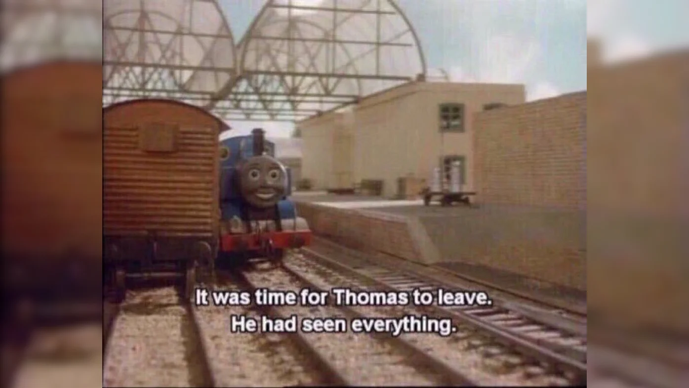 Thomas the Tank Engine at a train yard with subtitle reading 'It was time for Thomas to leave. He had seen everything.'
