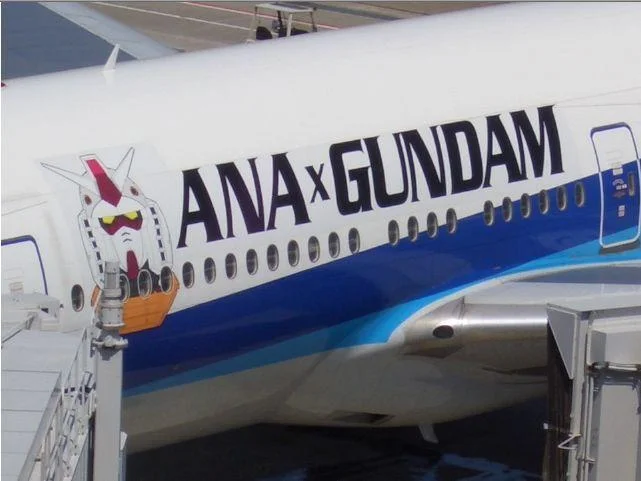 Itasha — ANA passenger jet with ANA x Gundam branding and RX-78 Gundam head on nose