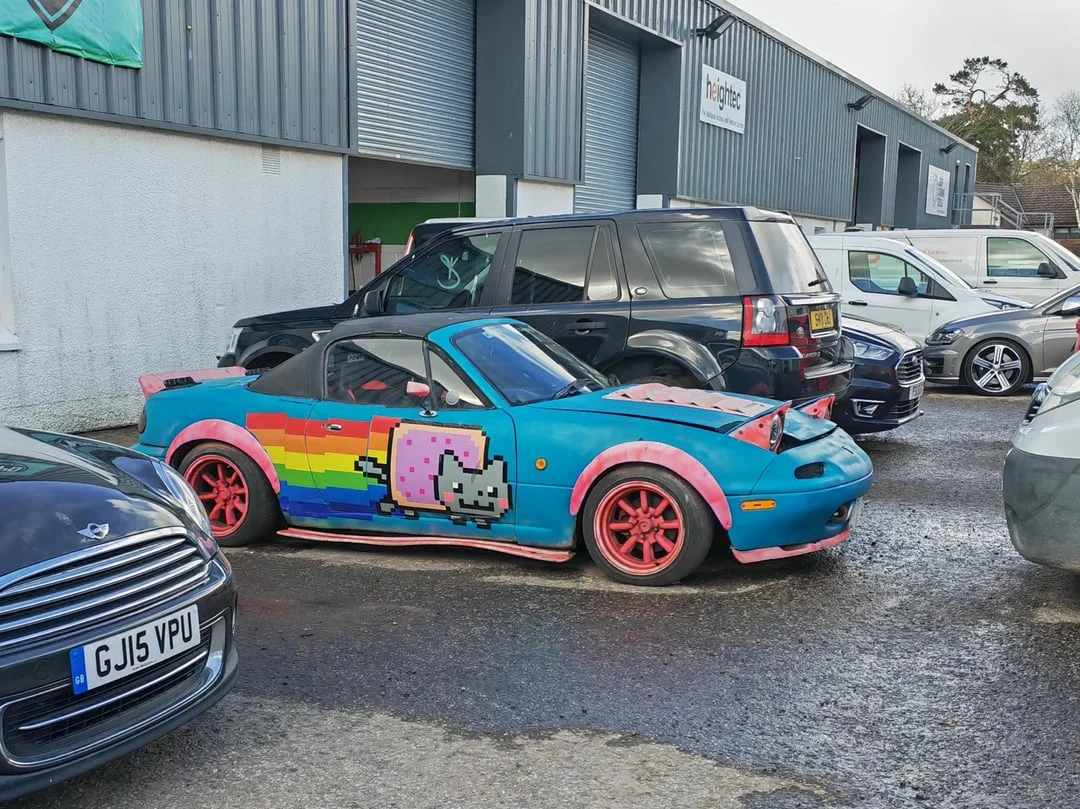 Itasha — Teal Mazda MX-5 Miata with Nyan Cat rainbow decal and pink fenders