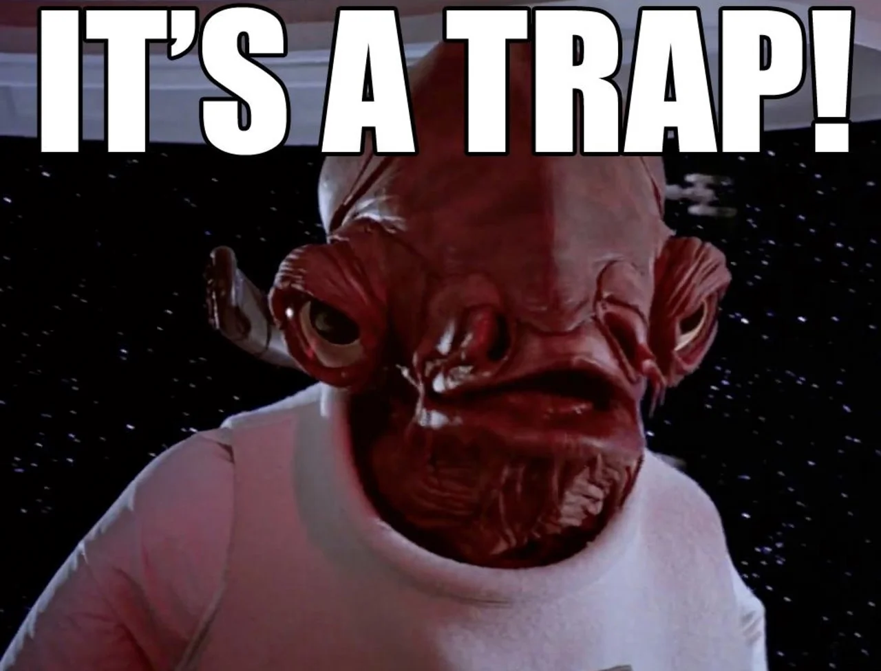 Close-up film still of Admiral Ackbar with 'IT'S A TRAP!' in large bold white Impact font.