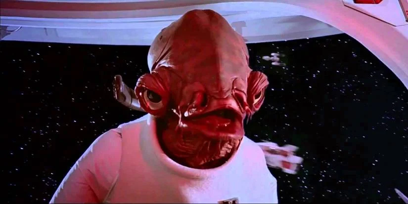 It's a Trap — Clean widescreen film still of Admiral Ackbar in white uniform against starfield.