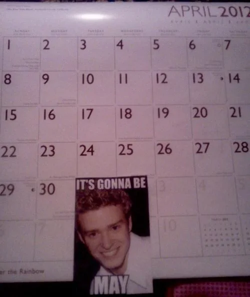 "It's Gonna Be May" — April 2012 wall calendar with an 'It's Gonna Be May' meme cutout placed on April 30