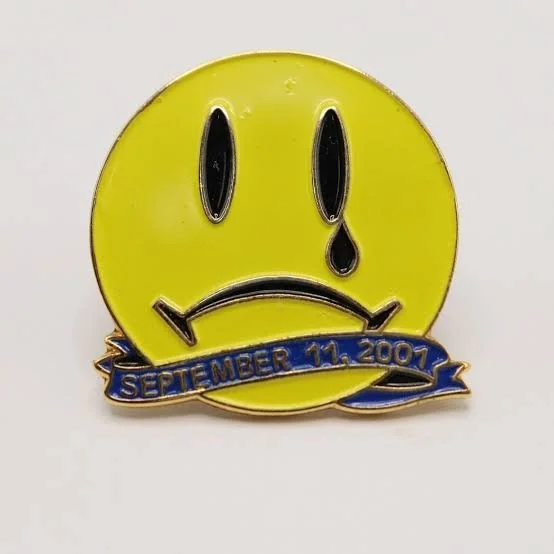 It's Me, It's Verity — Tweet screenshot showing a September 11, 2001 memorial smiley pin with the caption 'Hey it's me it's Verity'
