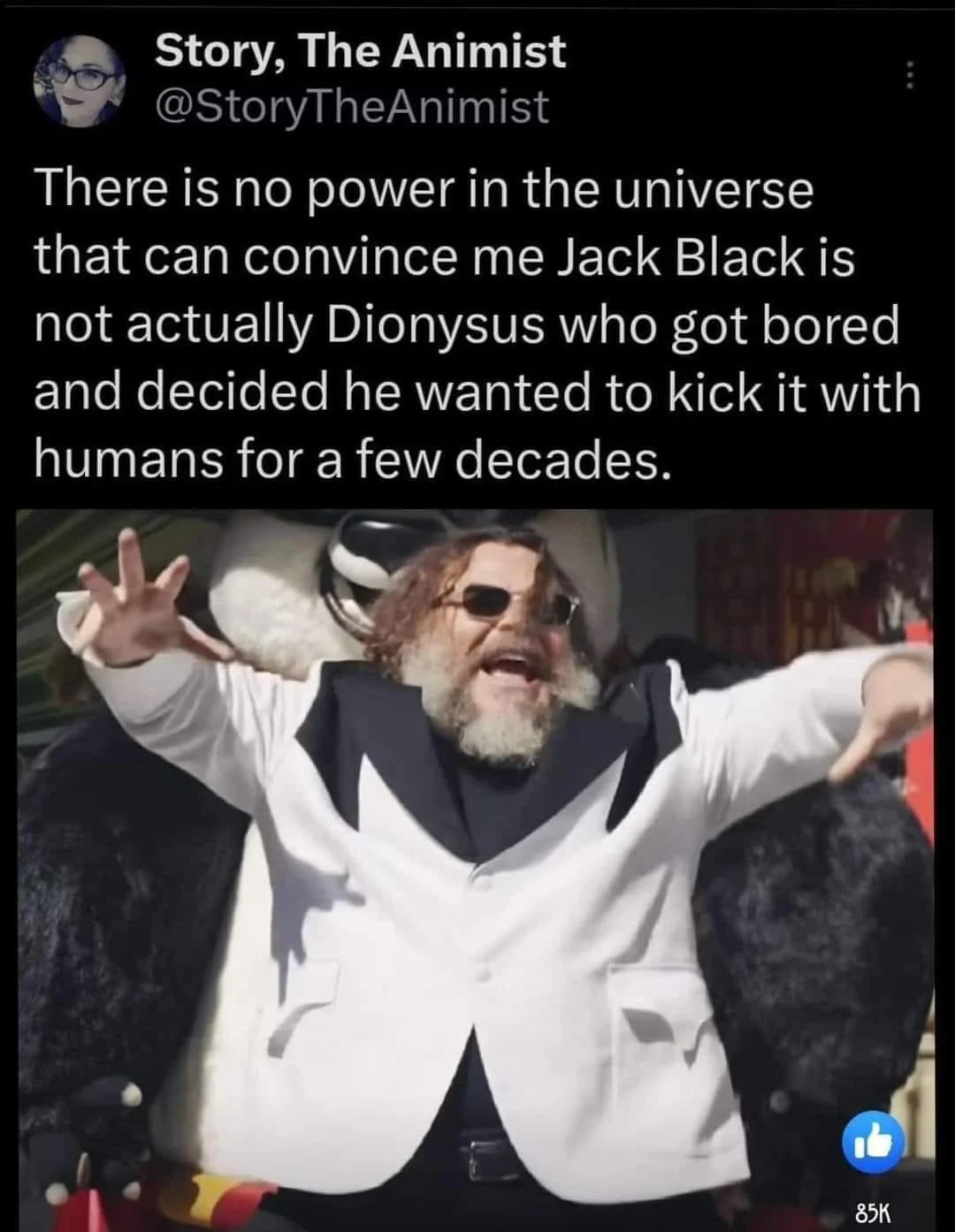 Tweet joking that Jack Black is the Greek god Dionysus, illustrated with a photo of him in white tuxedo and sunglasses with arms spread wide