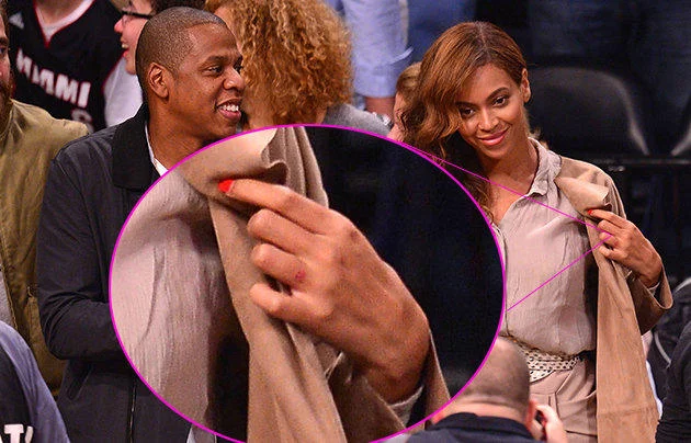 Jay-Z and Solange Knowles Elevator Fight — Jay-Z and Beyoncé courtside with a circle highlighting Jay-Z's hand
