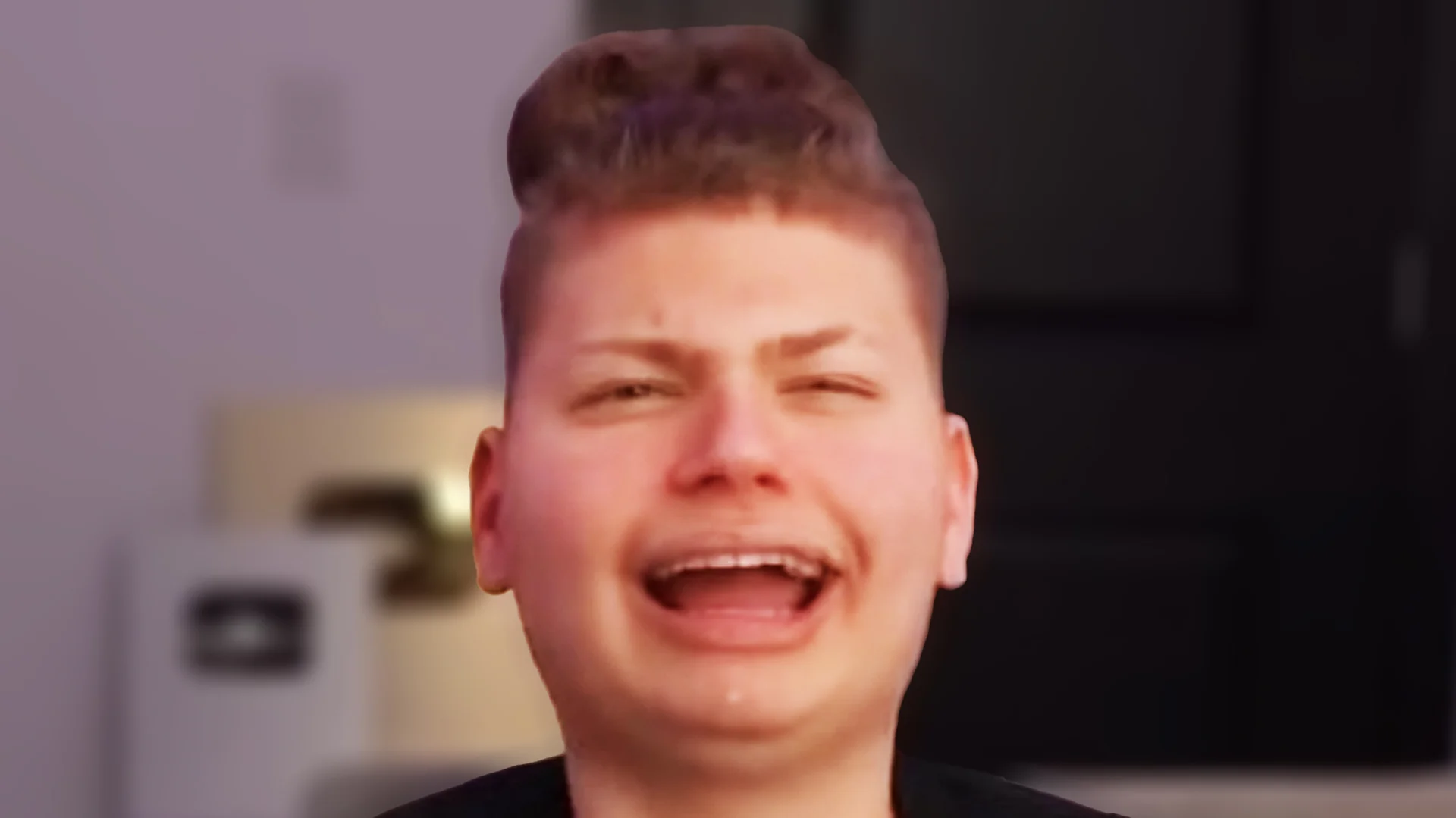 Jaydens Bus Is Here — Distorted close-up of a laughing boy with an exaggerated tall haircut