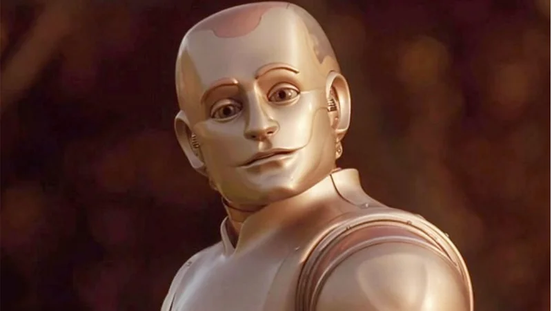 Jeff Bezos' "Alive Girl" Text — Metallic humanoid robot from the film Bicentennial Man looking sideways at the camera