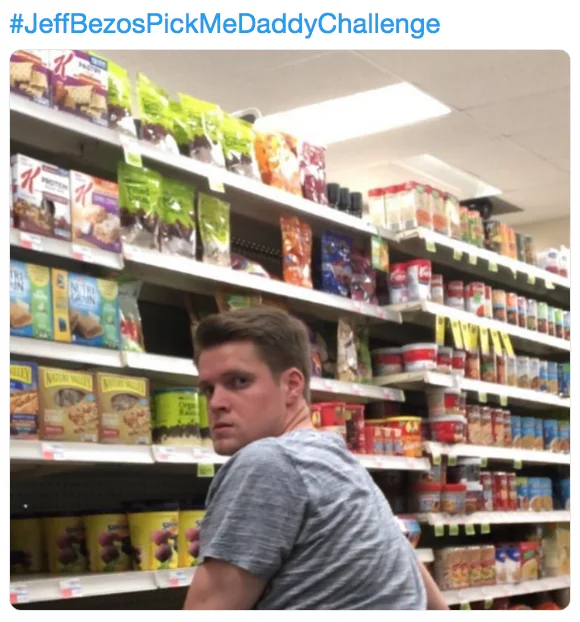 Jeff Bezos — Man looking back in a grocery store cereal aisle as part of the JeffBezosPickMeDaddyChallenge