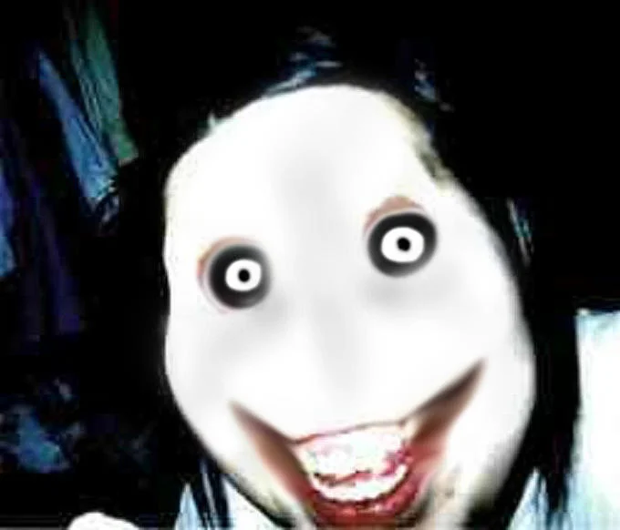 Clean close-up of Jeff the Killer displaying pale white face, dark eye sockets with black rings, and characteristic wide red mouth showing teeth.