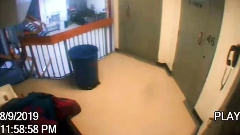 Jeffrey Epstein Cctv Footage Missing Minute — Single CCTV security footage frame from Jeffrey Epstein's jail cell showing the hallway with timestamp 8/9/2019