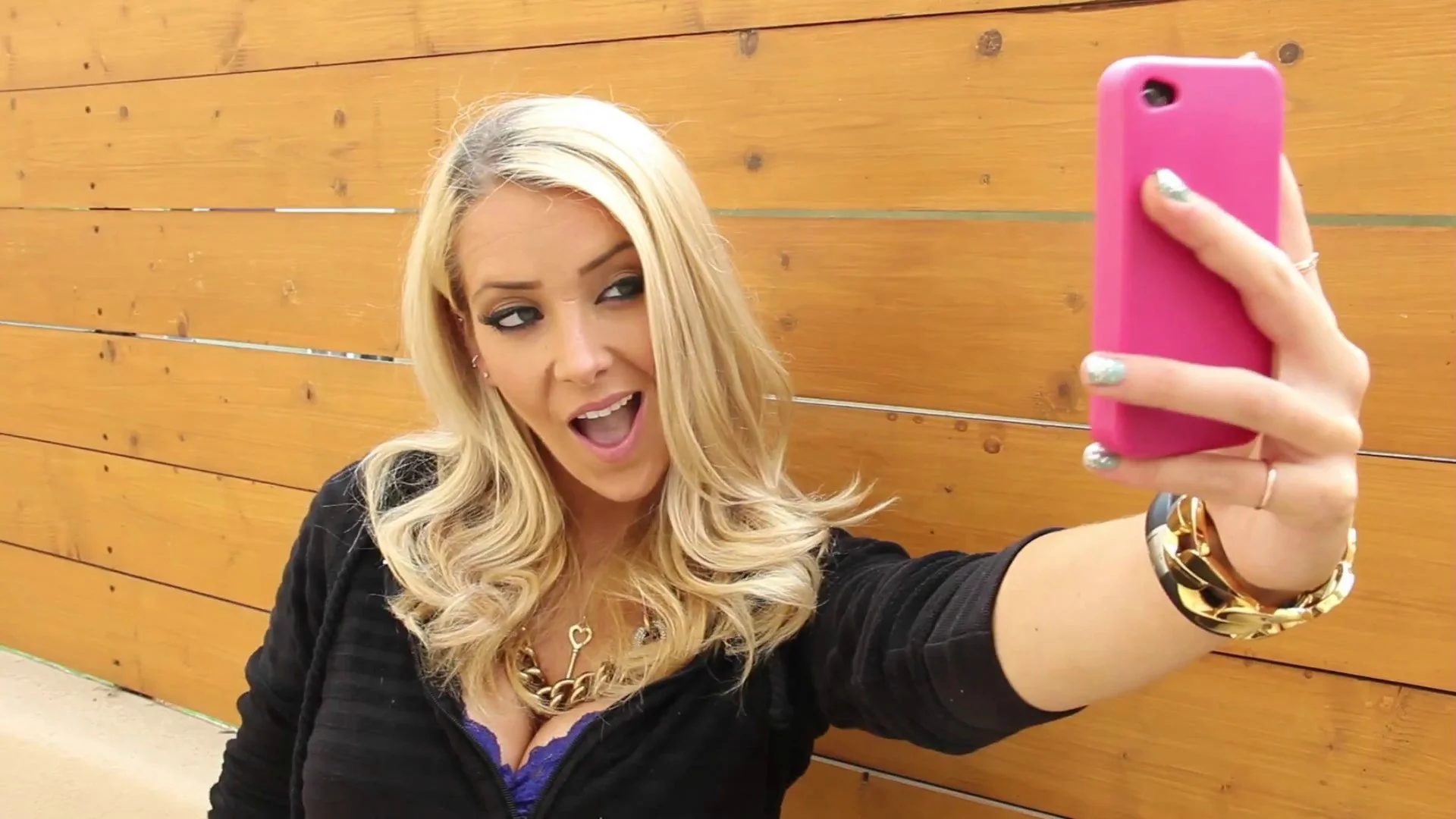 Jenna Marbles taking a selfie with a pink phone case