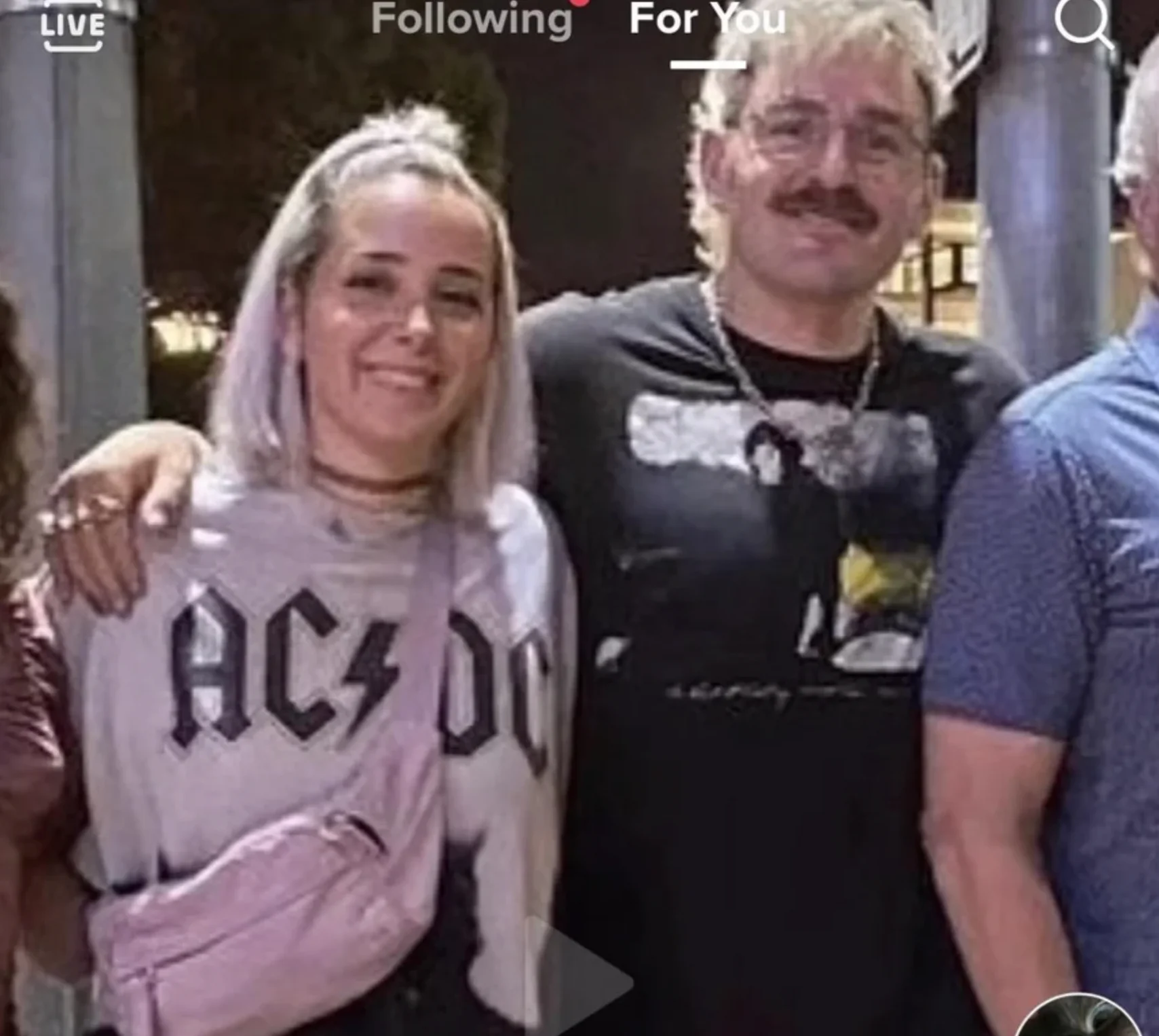 TikTok screenshot of Jenna Marbles posing with a fan in an AC/DC shirt