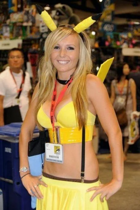 Jessica Nigri at a convention wearing a yellow Sexy Pikachu cosplay with Pikachu ears