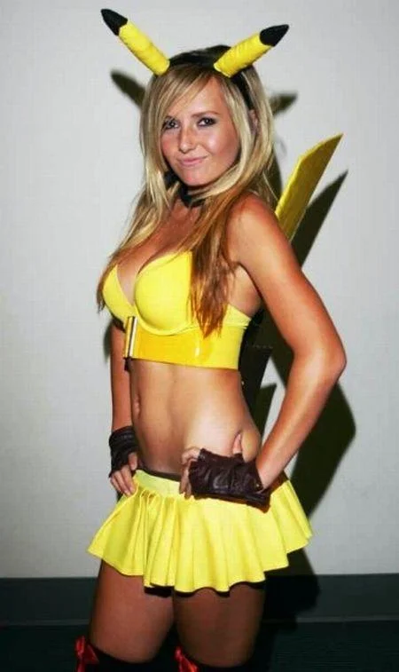 Jessica Nigri posing in a full-body Sexy Pikachu cosplay with yellow bra top and skirt