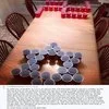 Jews Vs Nazis Beer Pong — A low-resolution photograph showing plastic cups arranged on a wooden table in a beer pong game setup.