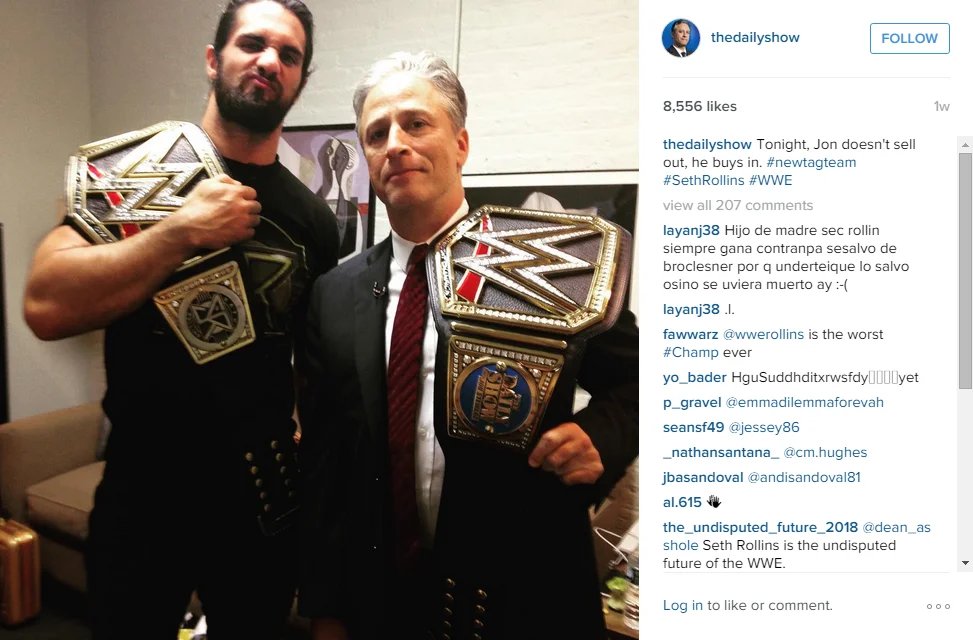 Instagram post of Jon Stewart posing with WWE's Seth Rollins holding championship belts