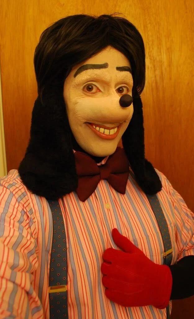 Jonathan Galindo — Dusky Sam cosplayer in Goofy-inspired human-dog costume giving a thumbs up