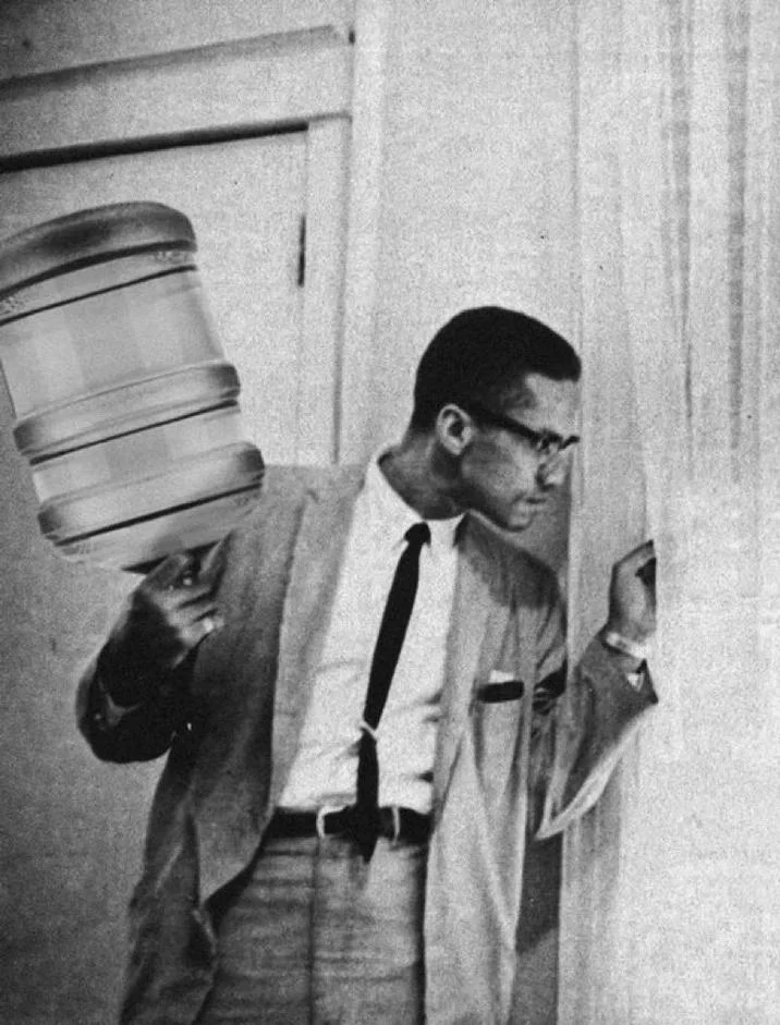 Jug Of Justice Bonk The Police — Malcolm X photo edit with a water jug replacing his rifle
