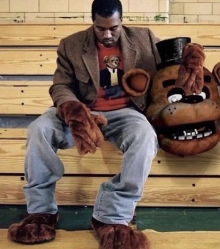 Kanye Is Golden Freddy Can I Have The Nitrus Today — Kanye West on the 808s & Heartbreak bench holding a Freddy Fazbear head