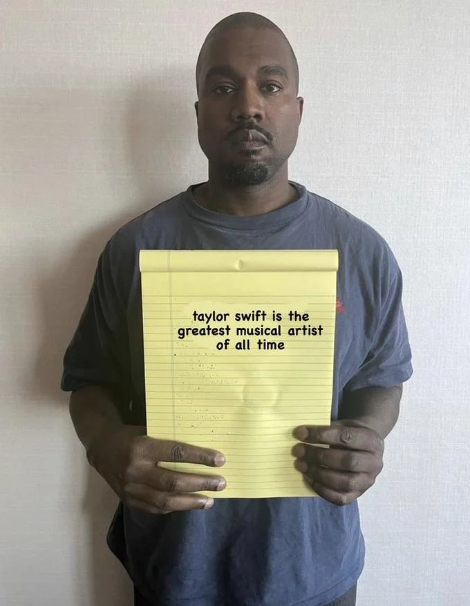 Kanye West holding notepad with 'taylor swift is the greatest musical artist of all time' digitally added.