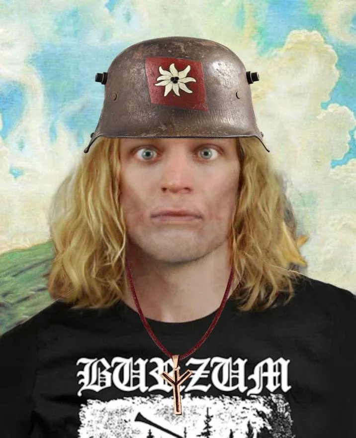 Kash Patel Ill See You In Valhalla — Photograph of man with long blonde hair in steel Viking helmet with horns wearing black metal band shirt.